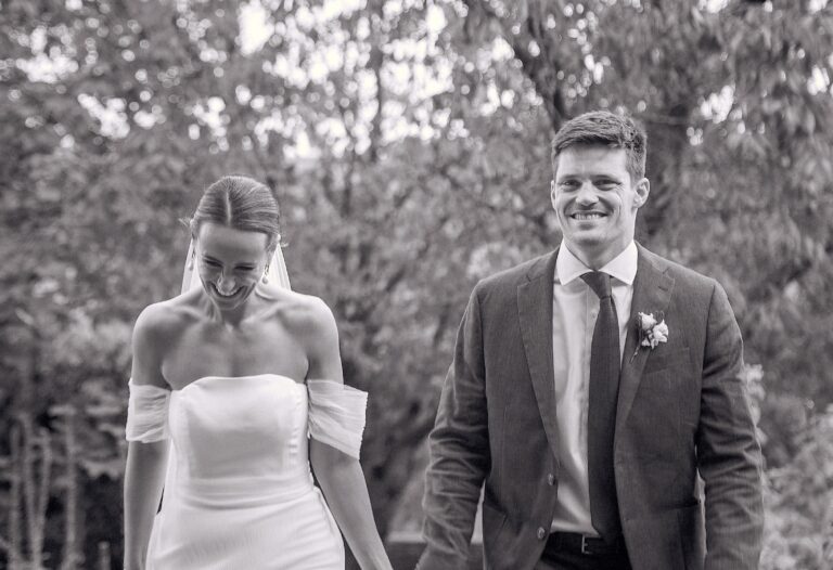 Black and white frame of the couple laughing together in a garden, Gorgeous Films
