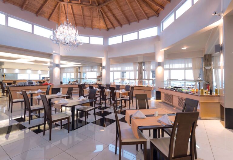 A restaurant dining room under a timber roof, Grand Blue Kos Hotel