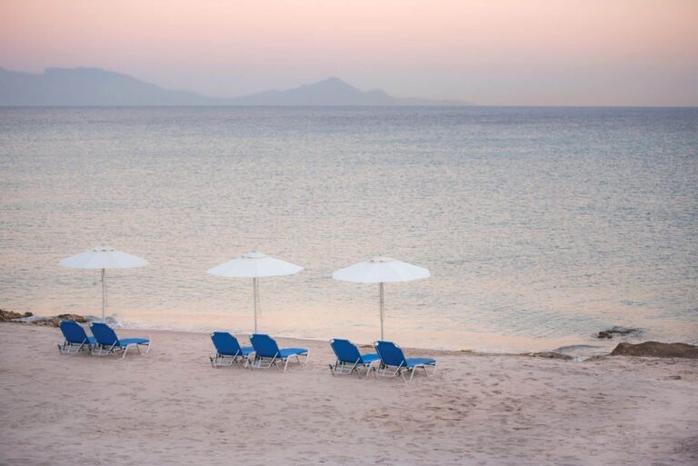 Sun loungers and parasols on the beach at dawn, Grand Blue Kos Hotel