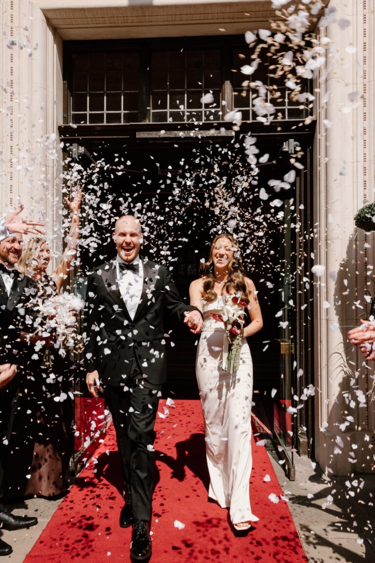 Couple leaving the hotel entrance under confetti on a red carpet, The Grand Hotel & Spa York