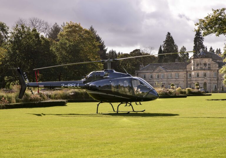A helicopter parked on the lawn in front of the Hall, Grantley Hall