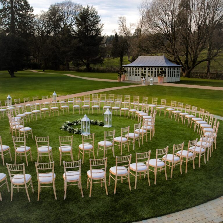 Chairs arranged in a spiral for a lawn ceremony, with the Summer House behind, Grantley Hall