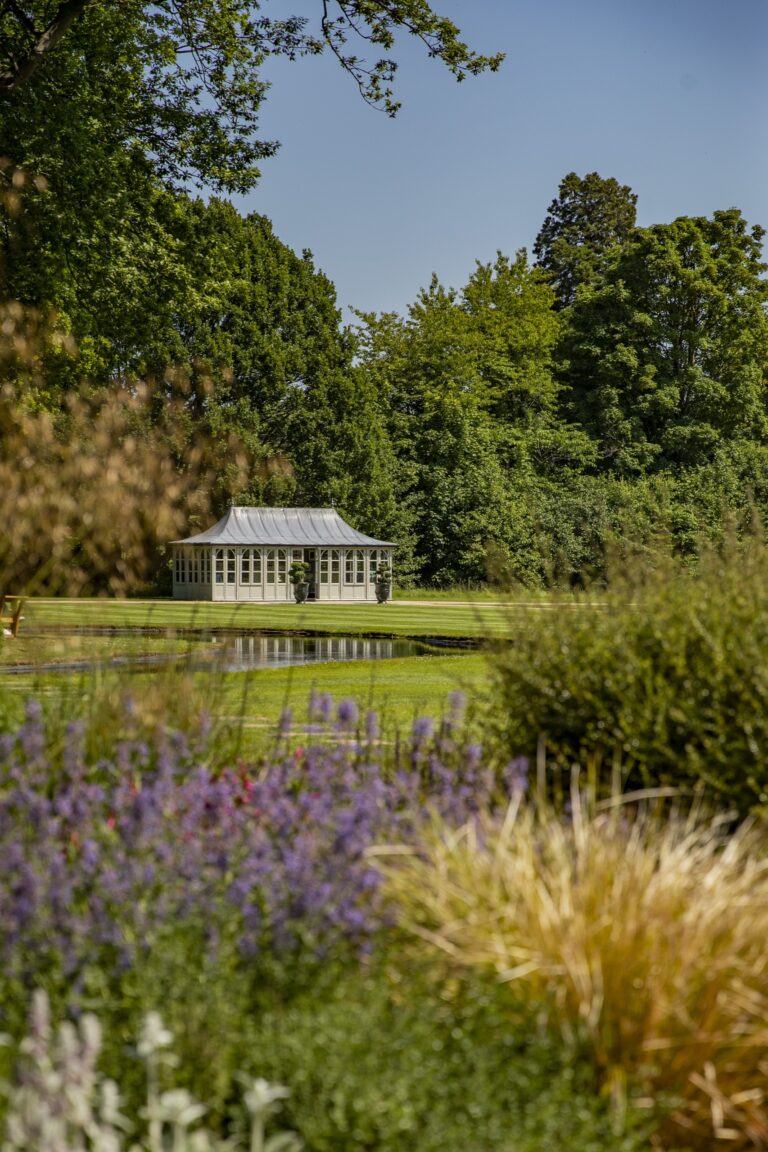 The Summer House on the front lawn, seen across lavender and a pond, Grantley Hall