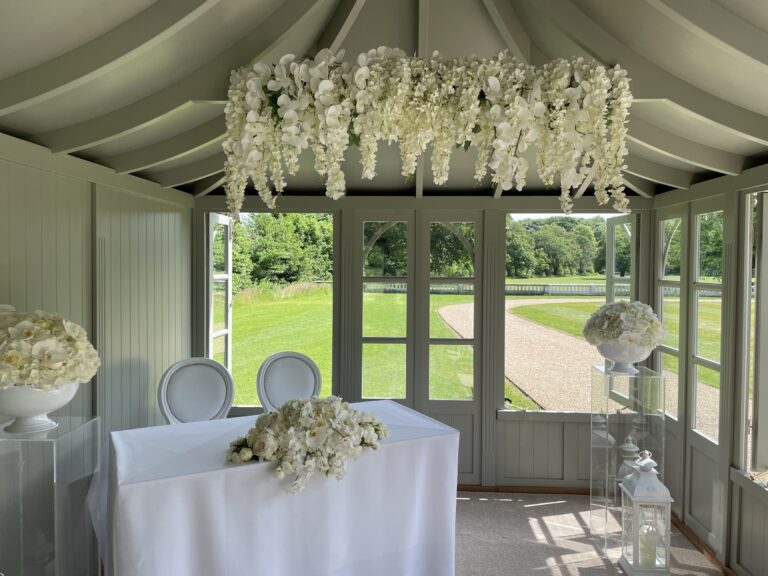 Inside the Summer House, with a registrar table and white flowers set for a small ceremony, Grantley Hall