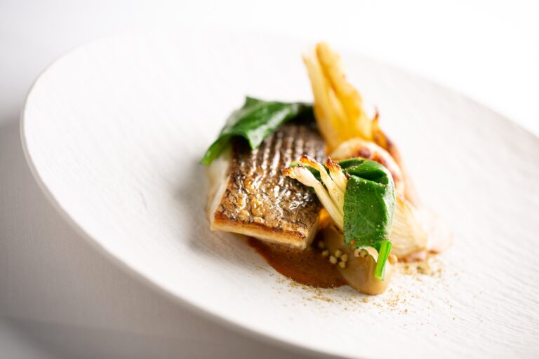 A plated fish course with charred fennel and greens, Grantley Hall