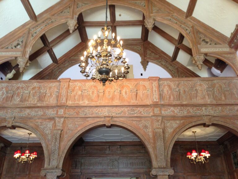 The beamed and vaulted ceiling of the Front Hall, with its wrought chandelier, Greystone Mansion