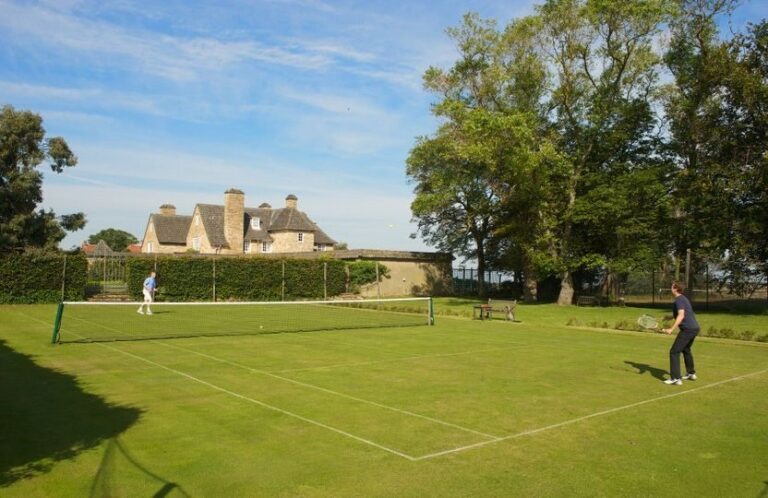 A manicured grass tennis court on the lawns below the house, Greywalls Hotel & Chez Roux