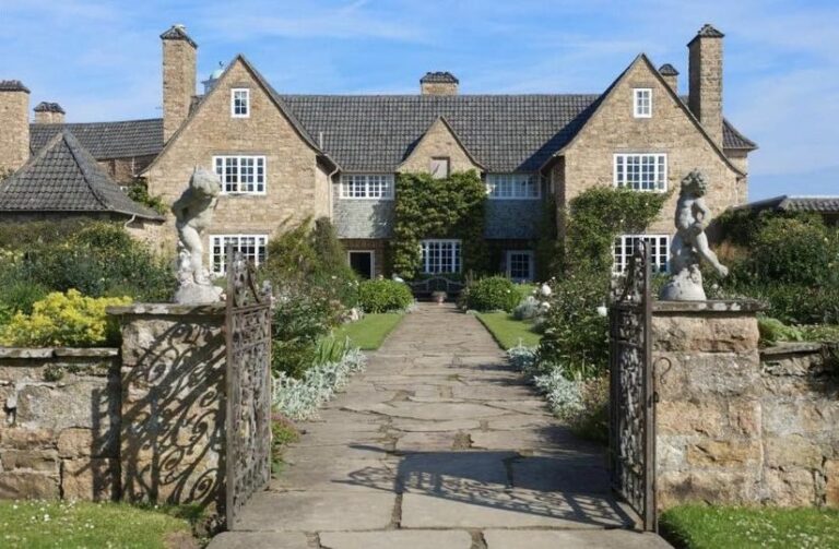The approach through the wrought-iron gates to the arms of the Arts & Crafts house, Greywalls Hotel & Chez Roux