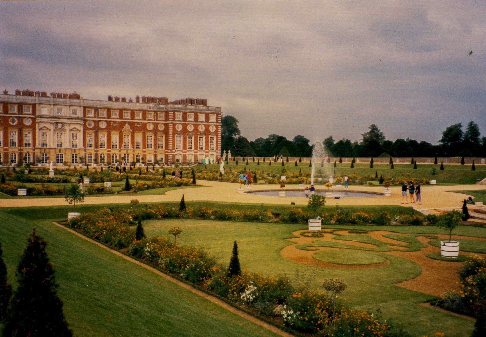 The Privy Garden's clipped parterres before the palace's Baroque south front in golden light, Hampton Court Palace