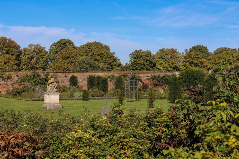 A walled garden of deep herbaceous borders and a statue in the palace grounds, Hampton Court Palace