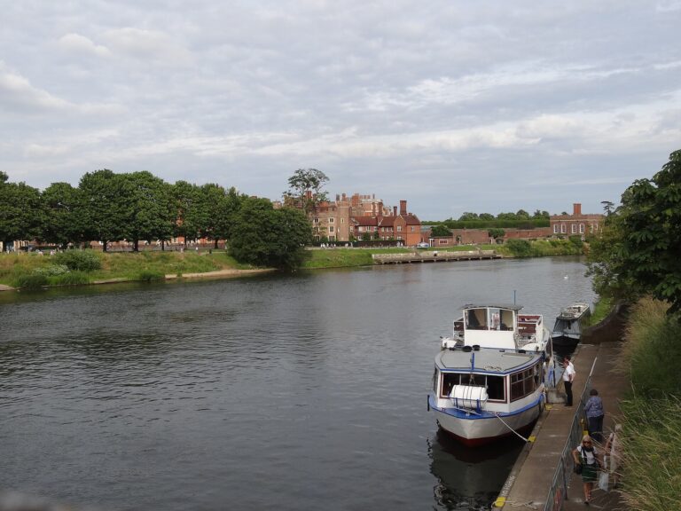 A pleasure boat moored on the River Thames below the palace, Hampton Court Palace