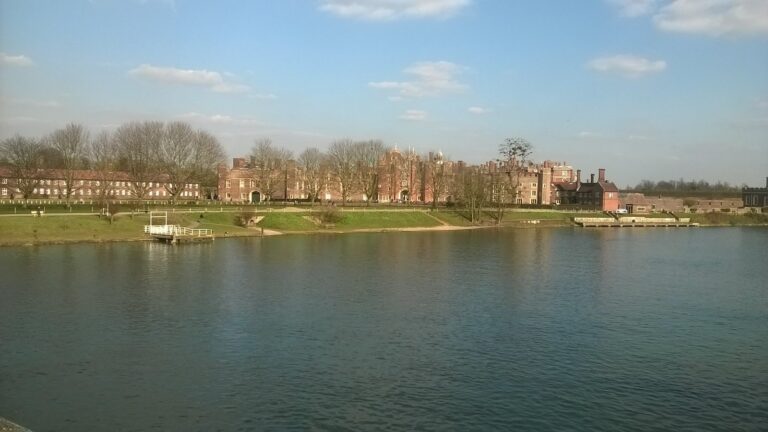 The palace low across the broad, calm waters of the Thames, Hampton Court Palace