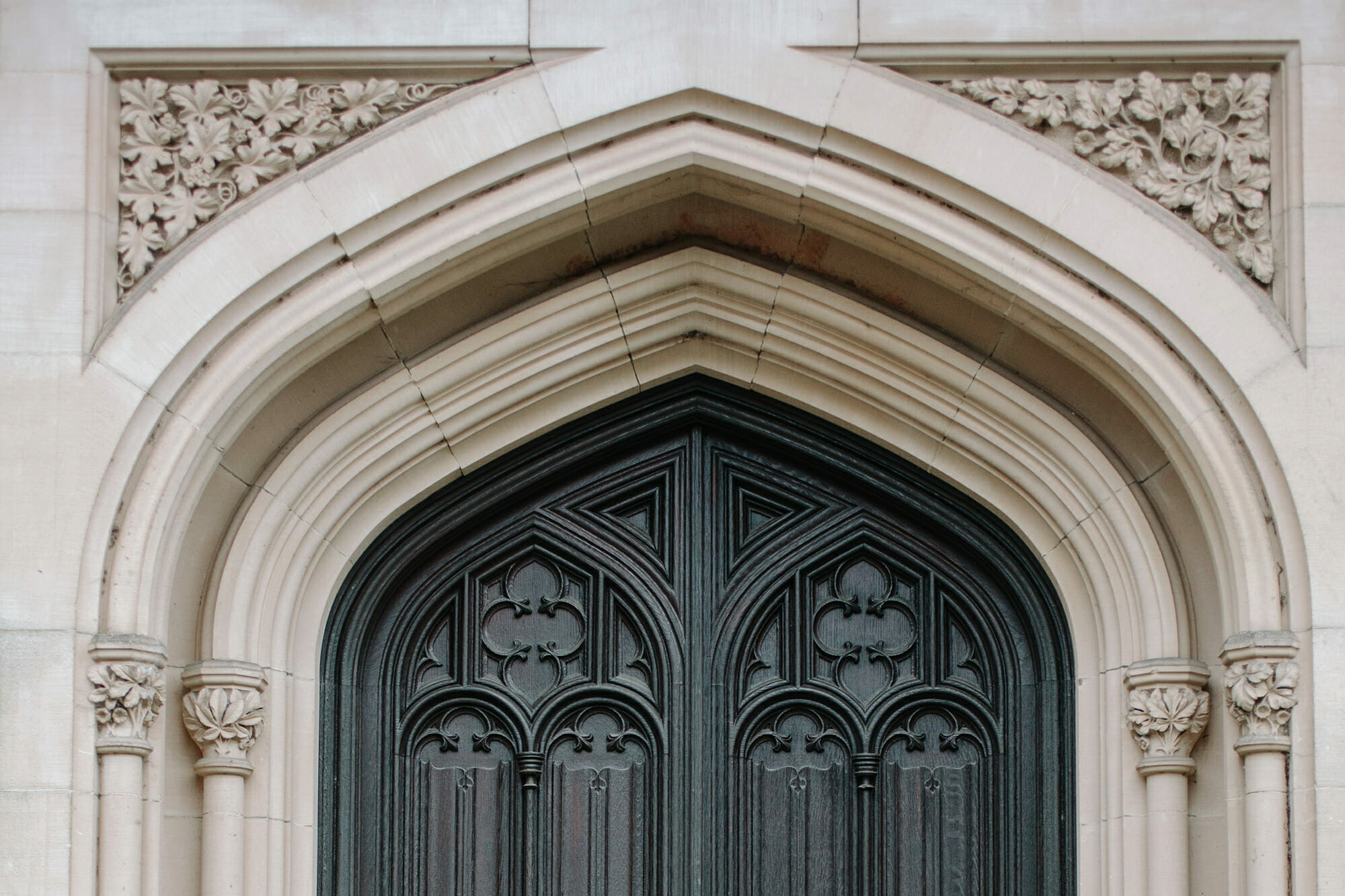 An ornate carved gothic-arched doorway on the estate, Hampton Manor