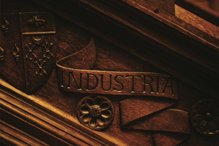 A carved crest reading INDUSTRIA, the Peel family motto, in the house, Hampton Manor