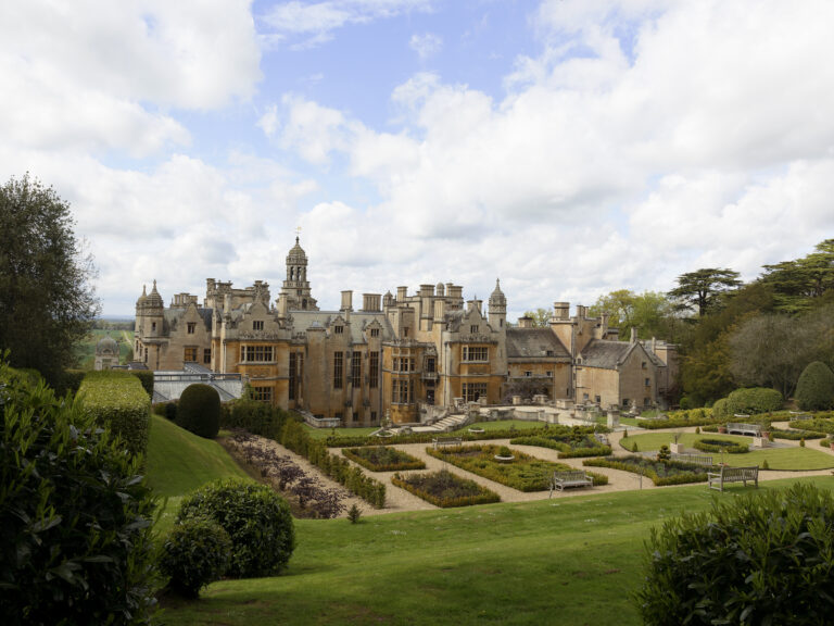 The formal parterre gardens laid out below the manor, with box-edged beds and lawns on the slope, Harlaxton Manor
