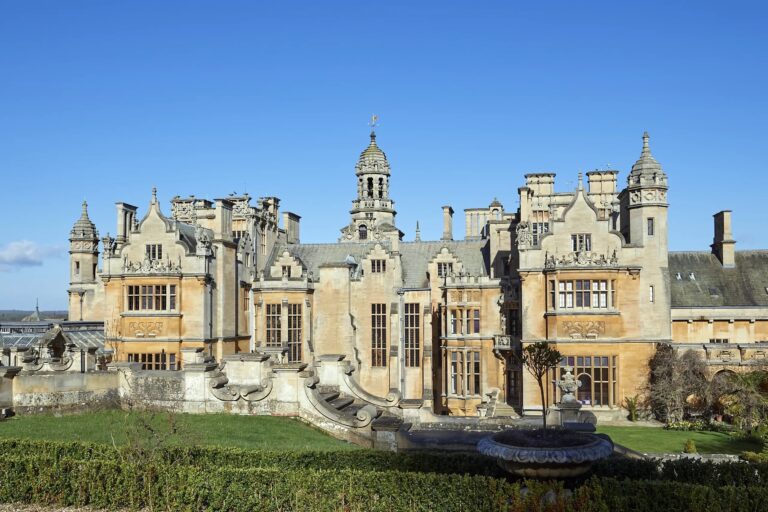 The south side of the manor above a sunken garden with a stone fountain basin and box hedges, Harlaxton Manor