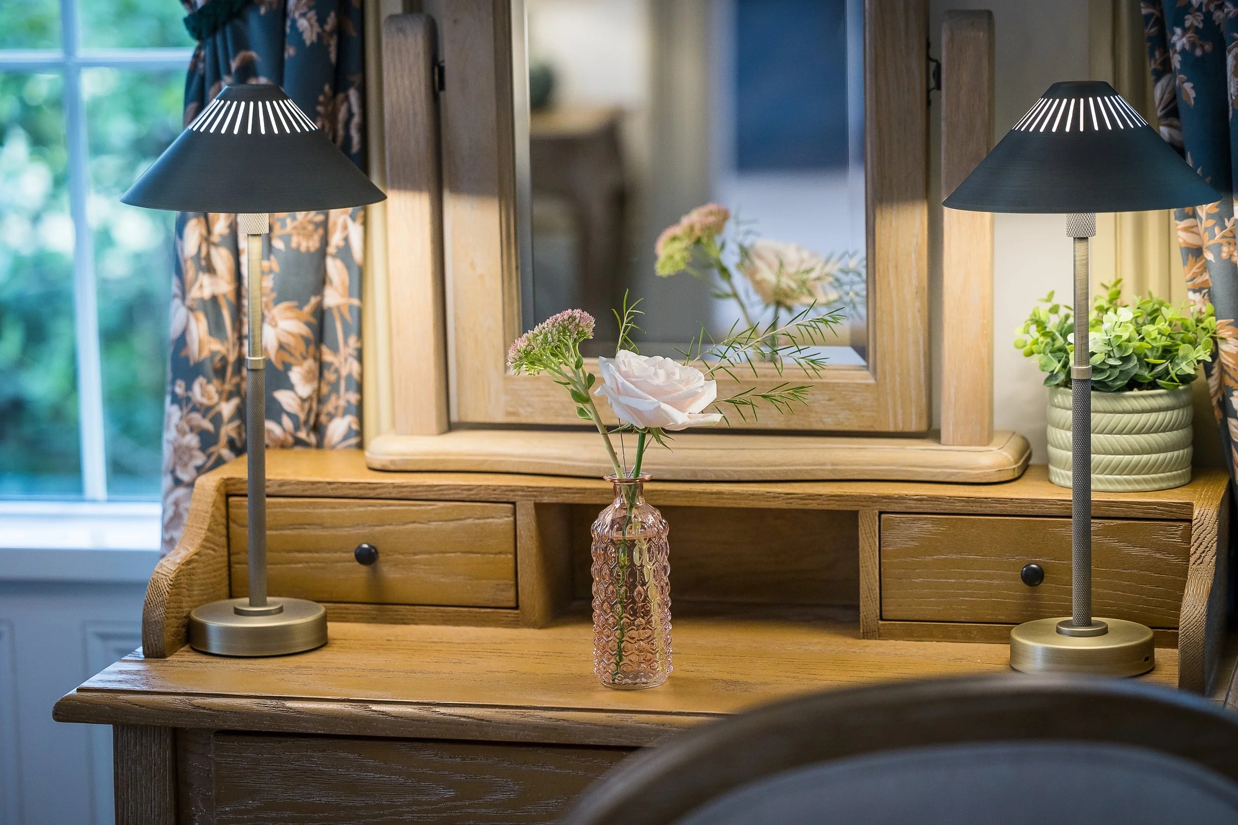 A dressing table with lamps and flowers in a guest room, Haselbury Mill