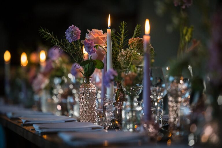 Candlelight and flowers along the wedding table, Haselbury Mill