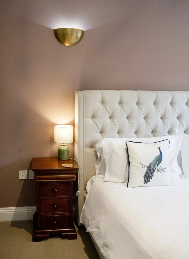 A guest bedroom with an upholstered headboard, Haselbury Mill