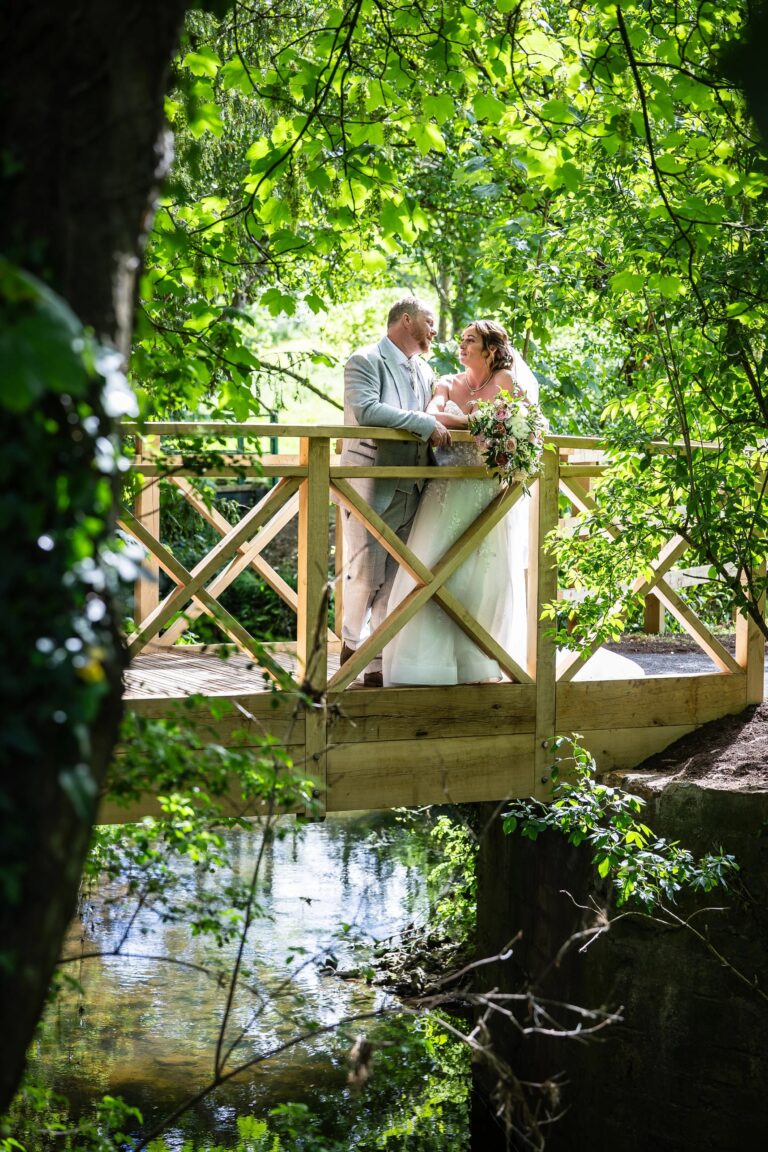 A couple on the bridge over the mill stream, Haselbury Mill