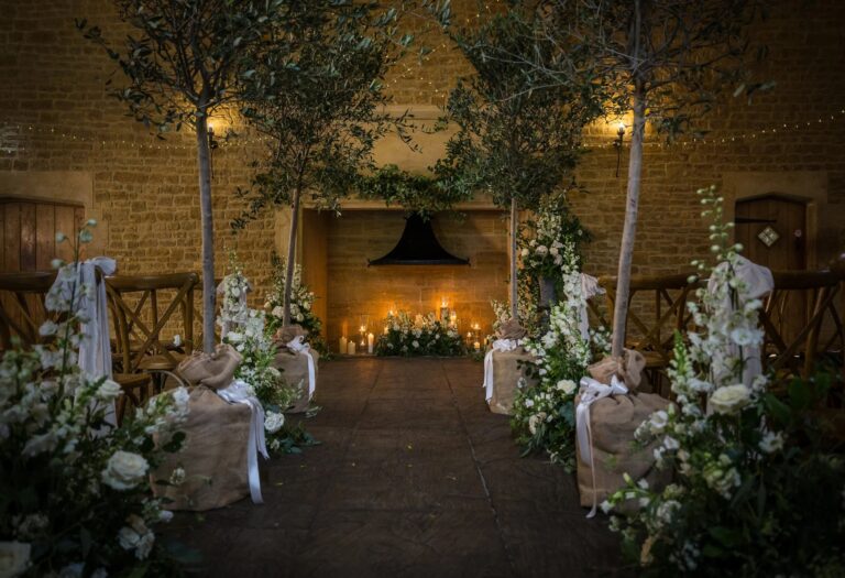 The Tithe Barn dressed with foliage pillars and candlelight, Haselbury Mill