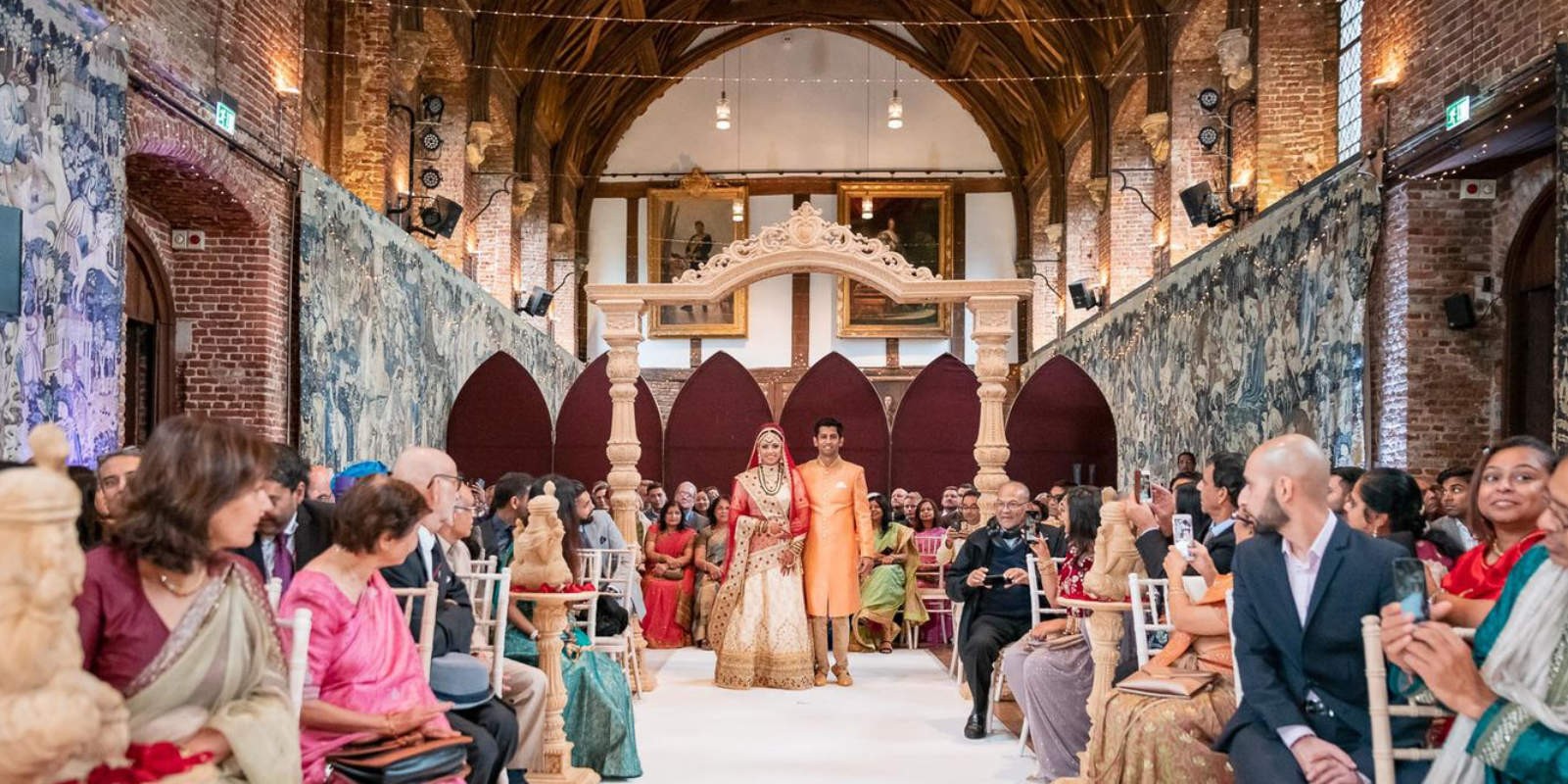 A ceremony in the Old Palace with guests along the aisle, Hatfield House