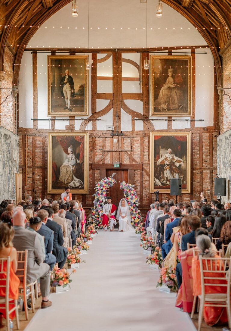 A ceremony in the Old Palace with guests seated either side of the aisle, Hatfield House