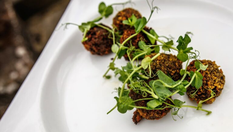Herb-topped canapes on a plate, Hatfield House