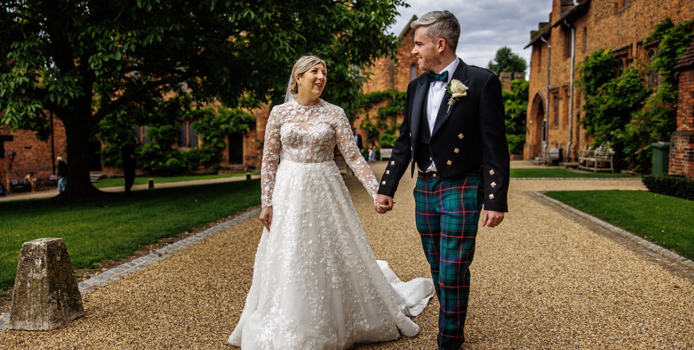 A couple walking along a gravel path in the grounds, Hatfield House