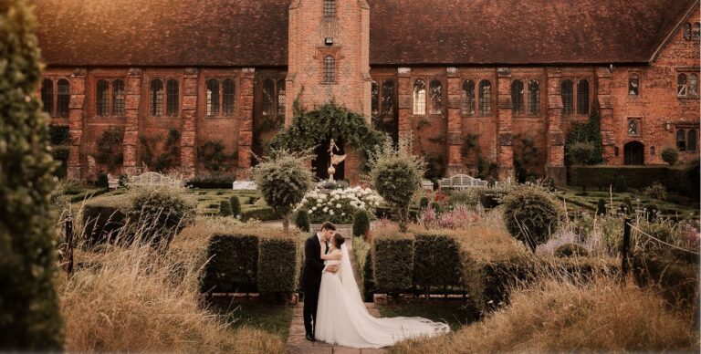 A couple in the Knot Garden with the Old Palace behind, Hatfield House