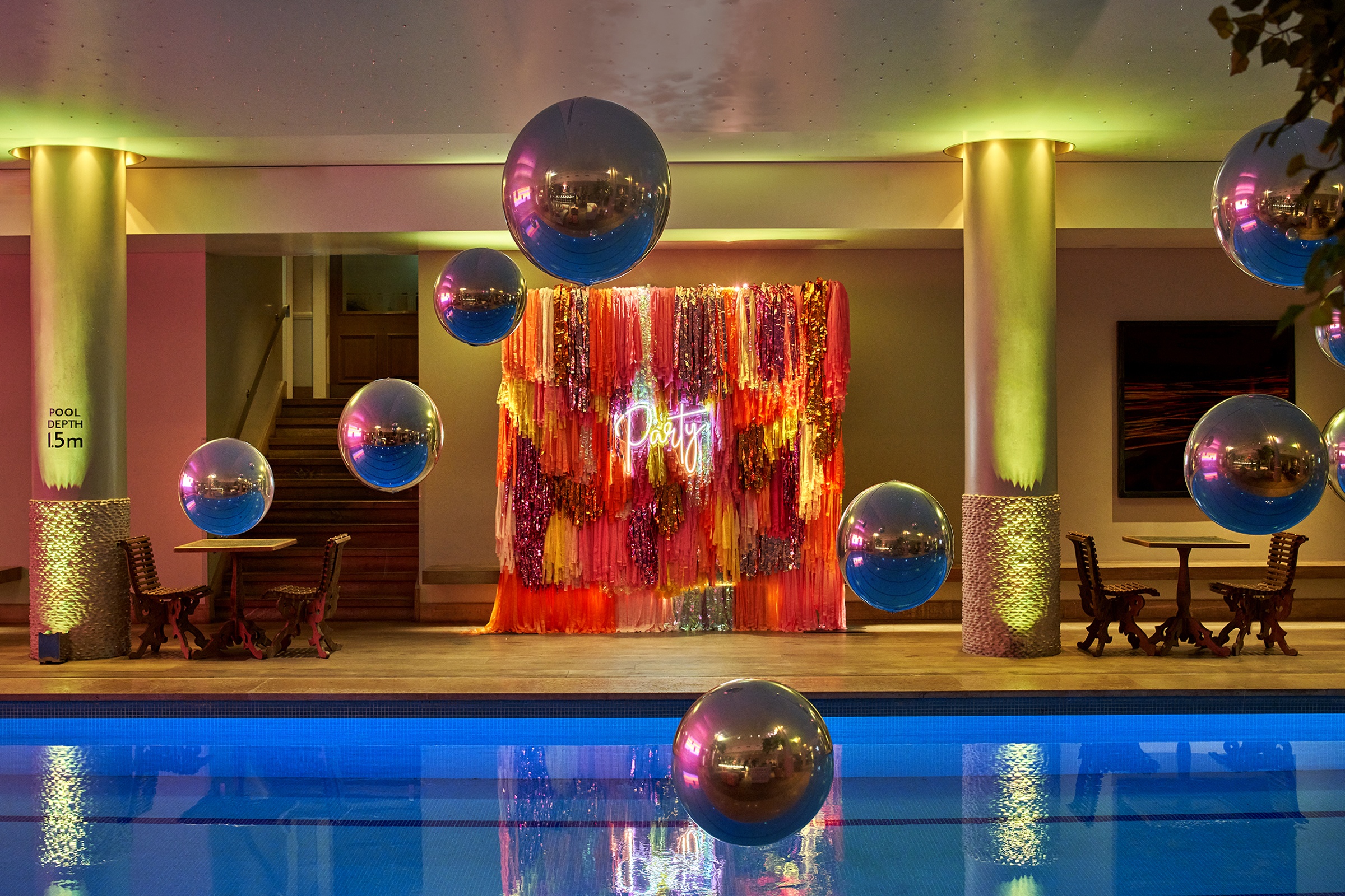 The underground pool dressed for a party, with balloons and lighting, Haymarket Hotel