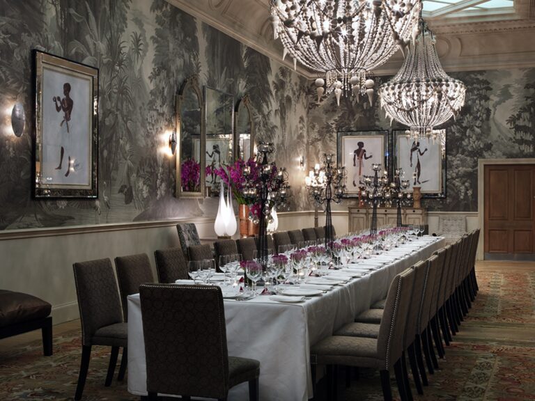 The Shooting Gallery, a long table set against the de Gournay hand-painted walls, Haymarket Hotel