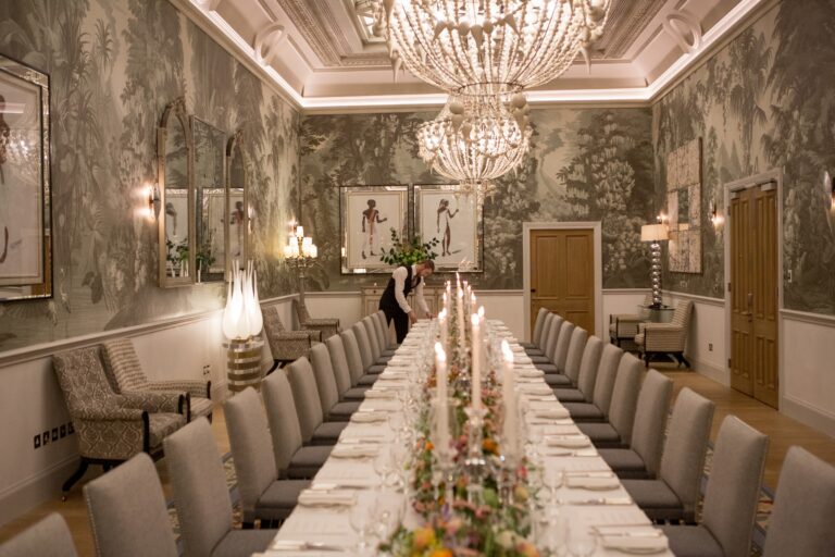 The Shooting Gallery, a wide long table with flowers and candles, Haymarket Hotel