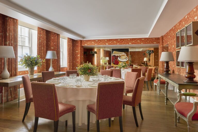 The Rocklin Room, two round tables against exposed brick, Haymarket Hotel