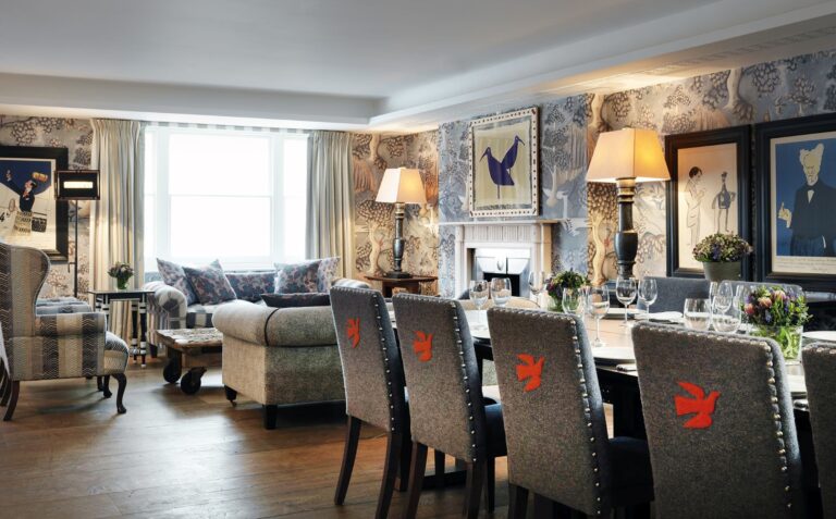 The Nash Room, a dining table and lounge in bold colour, Haymarket Hotel