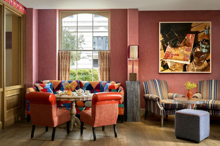 Brumus, a corner table against pink walls, Haymarket Hotel