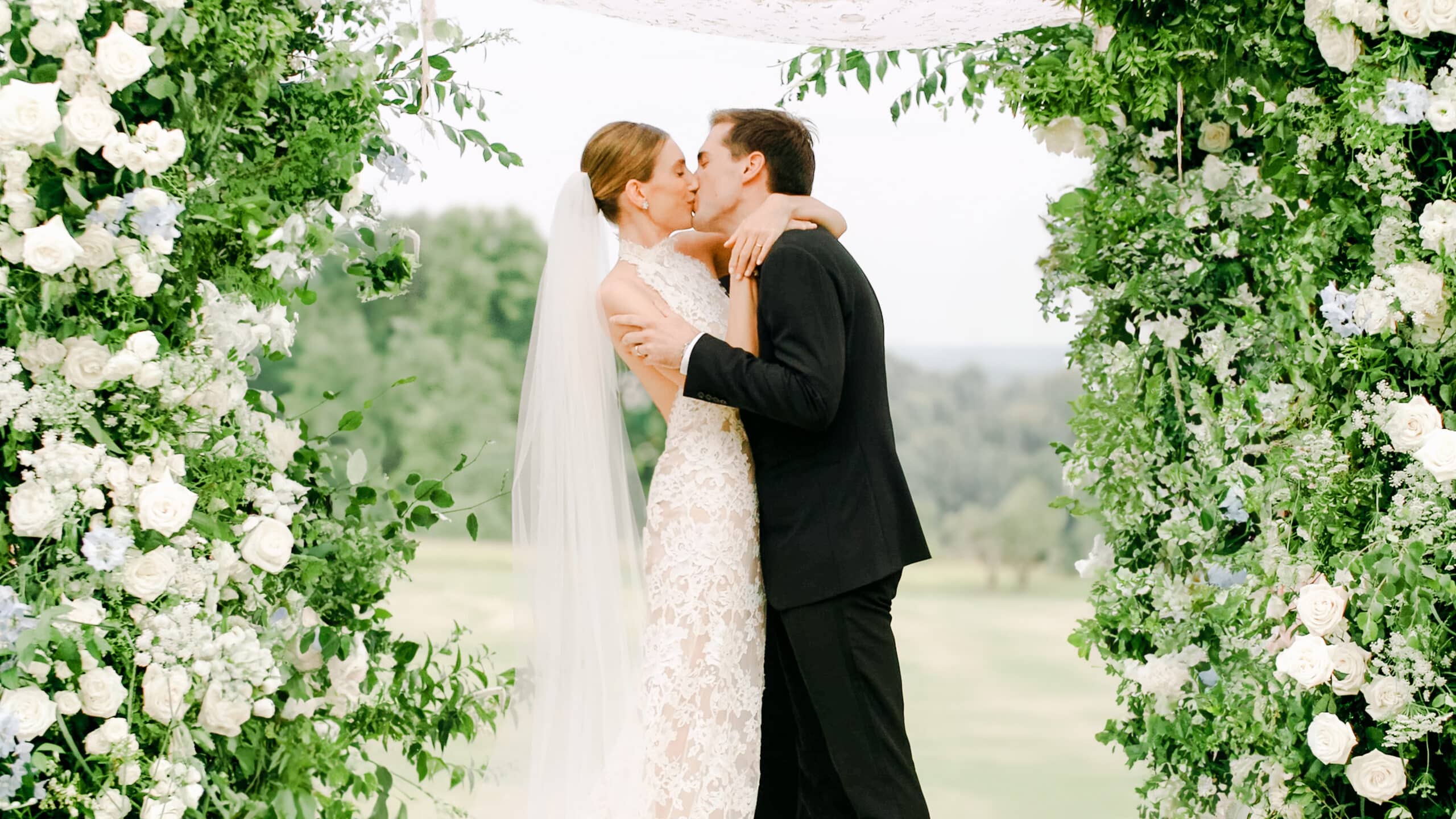 Mikaila and John's first kiss beneath a white floral canopy at Cliveden House, Berkshire (film still), HD Moments