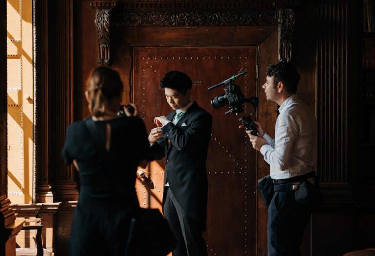Behind the scenes: the HD Moments team filming the groom getting ready in a panelled room, HD Moments