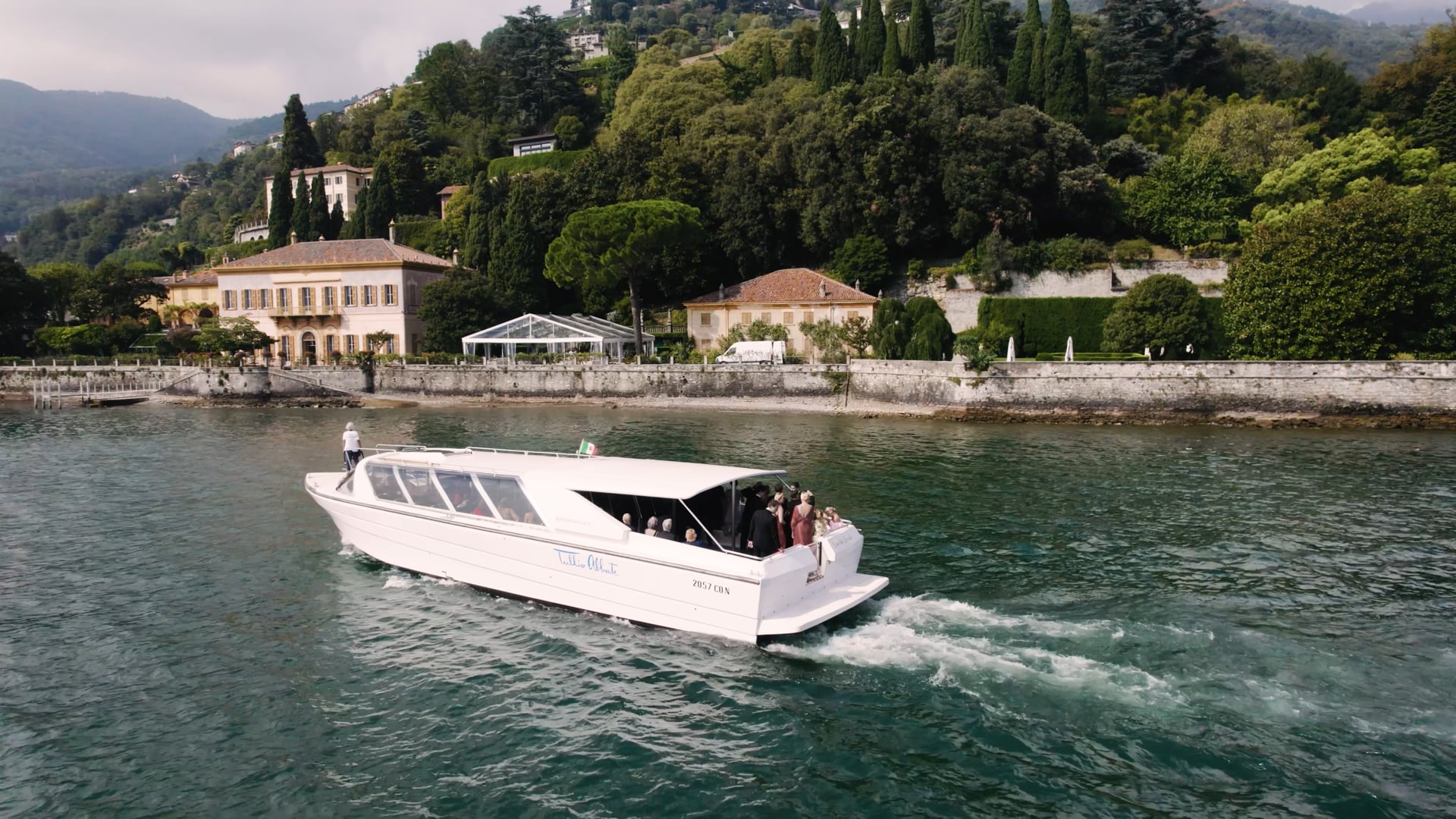 A launch crosses Lake Como below Villa Pizzo, from Bonnie and Brad's film, HD Moments
