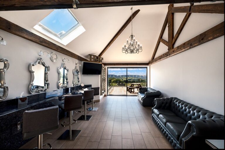 The Pamper Room, with mirrored make-up stations, a skylight, leather sofas and glass doors onto the decking, Heaton House Farm