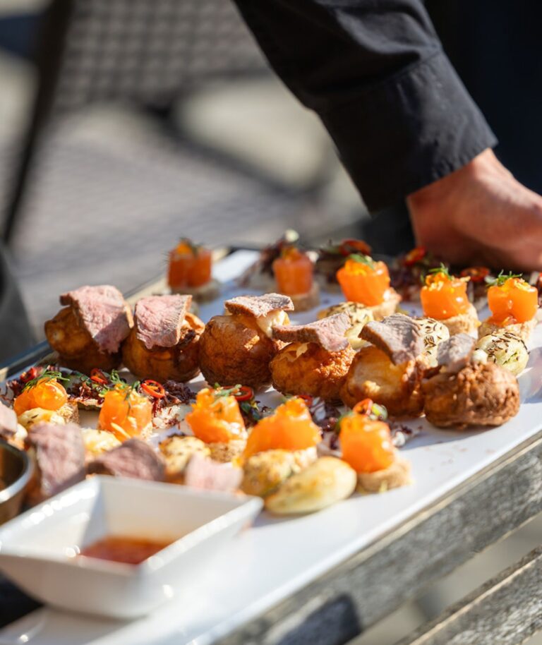 Canapés being plated, delicate smoked-salmon bites on a serving tray, Hengrave Hall