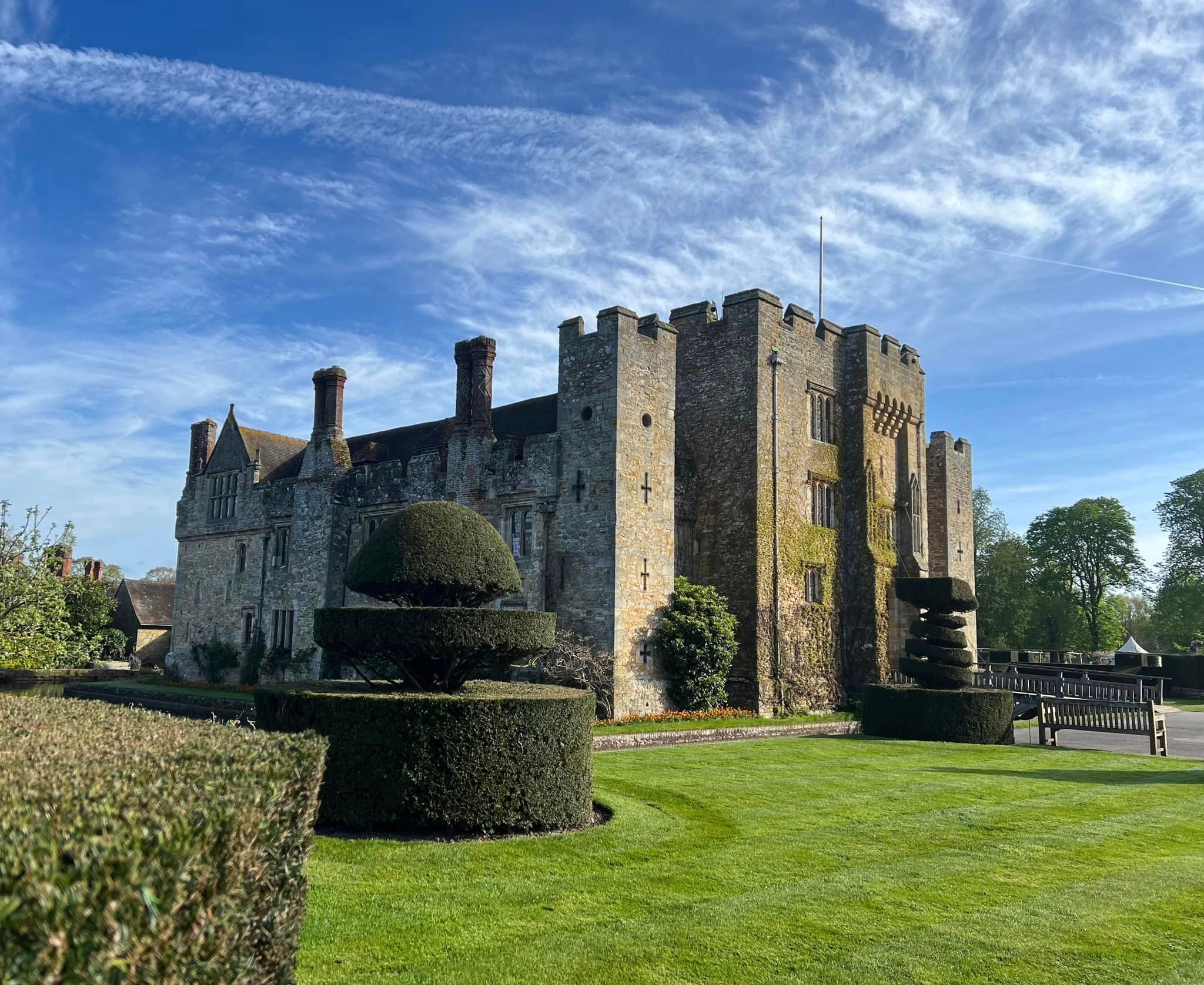 Hever Castle, the moated medieval castle, its battlemented tower above clipped topiary and lawn, Hever Castle