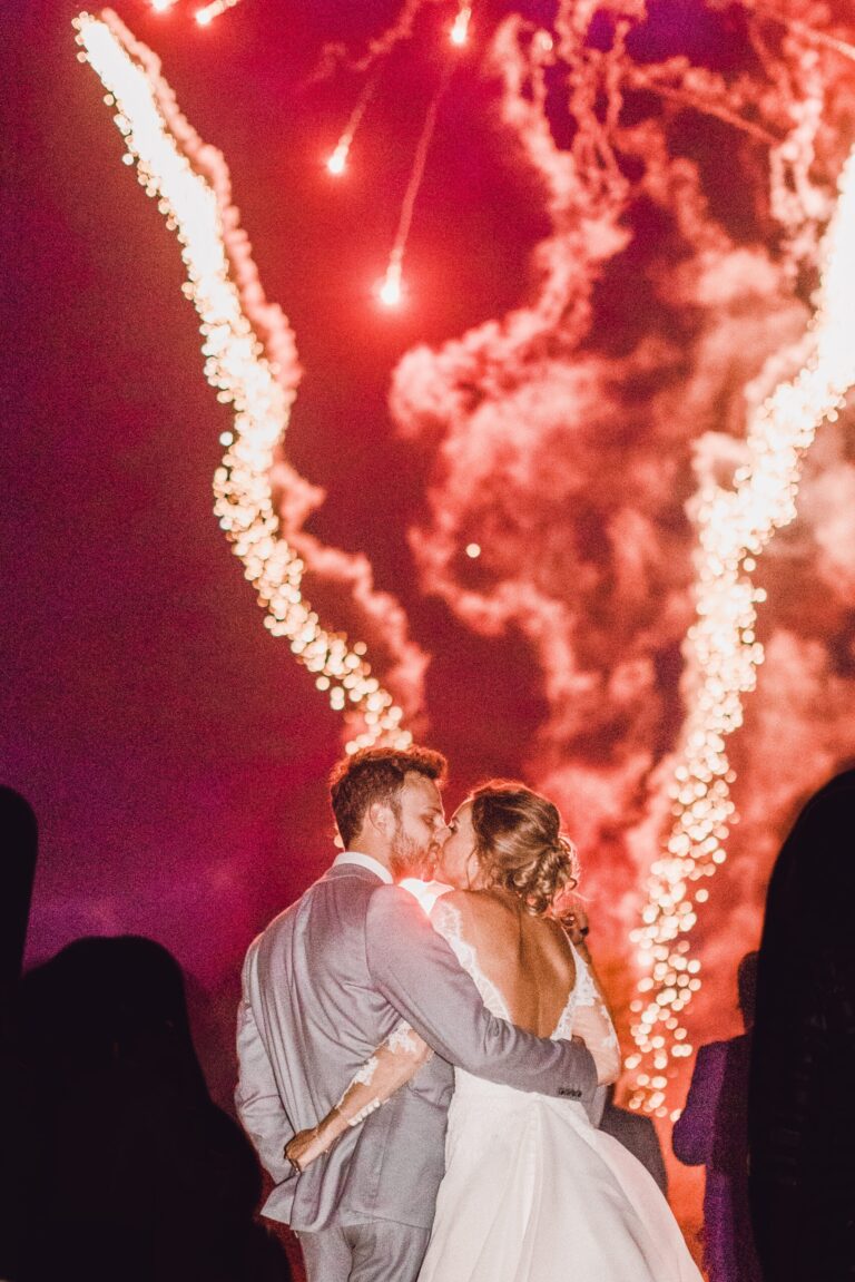 A couple embracing before a fireworks display in the grounds at night, Hever Castle