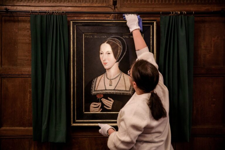 A Tudor portrait of Anne Boleyn displayed in a dark-panelled room at the castle, Hever Castle