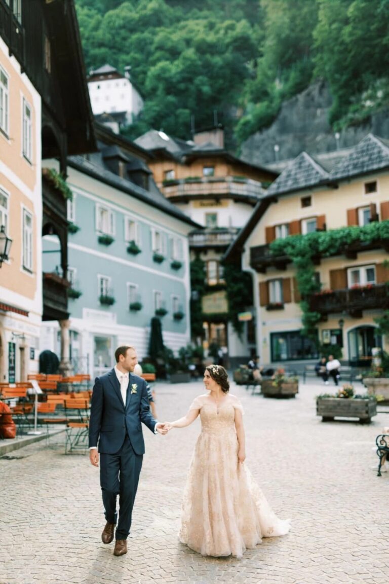 Couple walking through the village square in Hallstatt, High Emotion Weddings