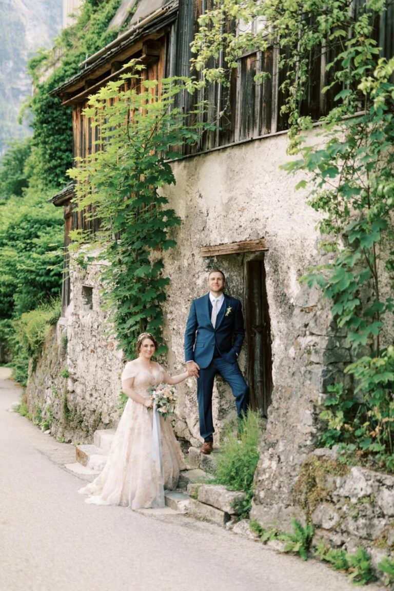 Couple beside an ivy-covered stone house, Hallstatt, High Emotion Weddings