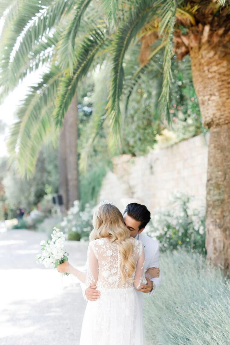 Couple embracing among palms, French Riviera, High Emotion Weddings