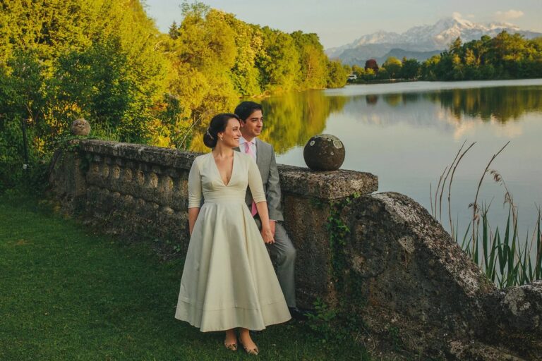 Couple beside a lakeside balustrade with Alpine views, High Emotion Weddings