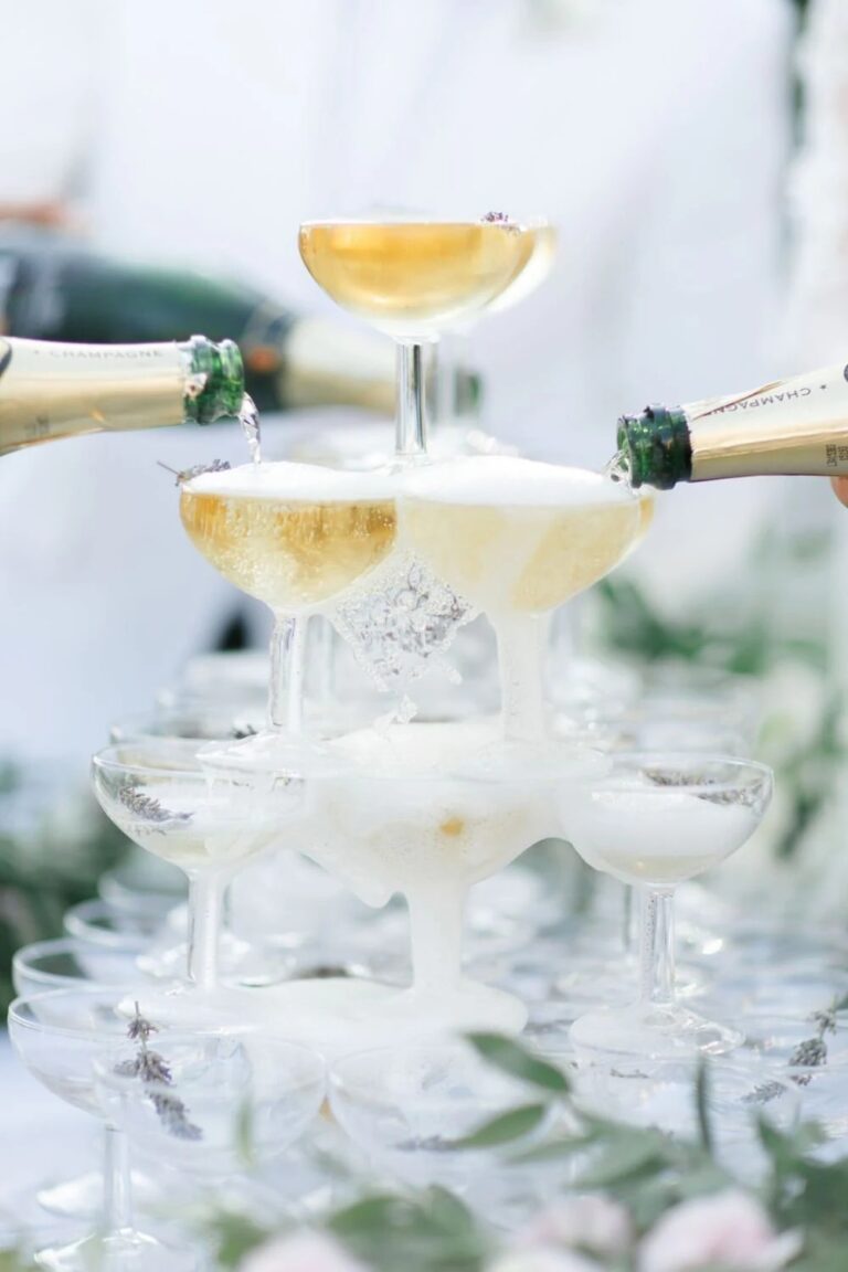 Champagne poured over a coupe tower, High Emotion Weddings