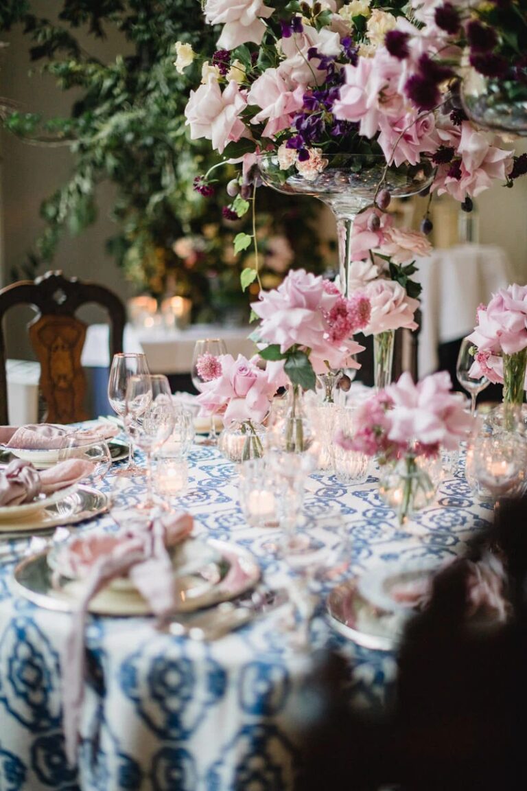 Table dressed in blue and white linen with pink florals, High Emotion Weddings